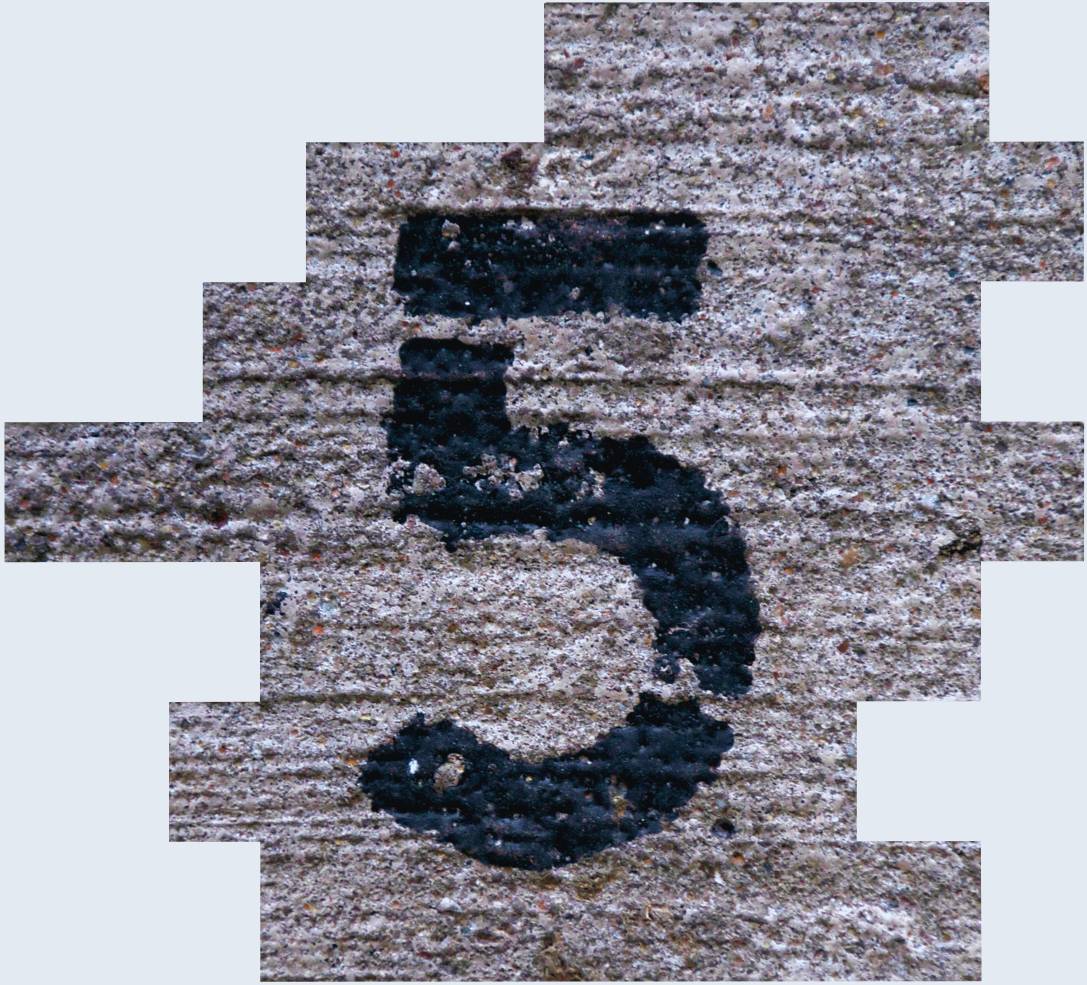 An image of the number five printed on an industrial background to illustrate the five areas of focus when it comes to shift work fatigue