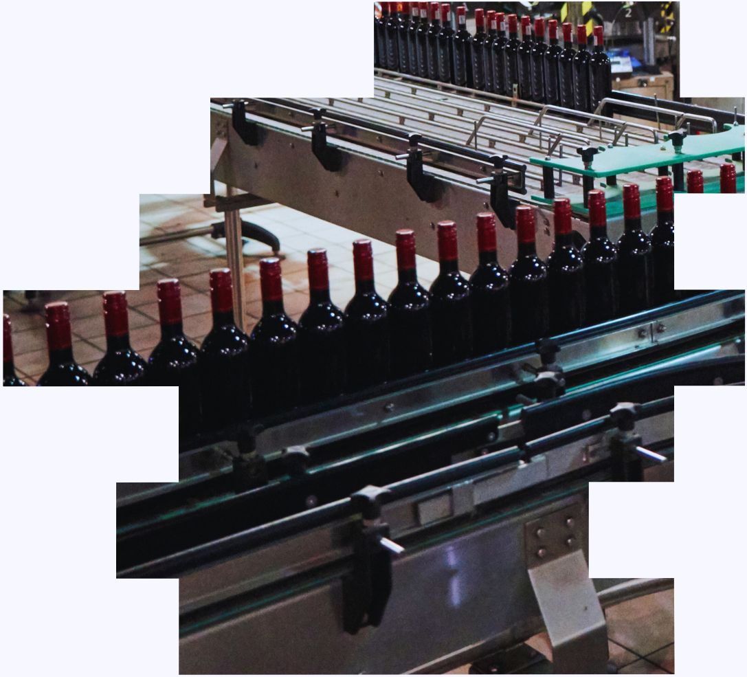 An image of bottles on a manufacturing line that shift workers are helping to fill with wine