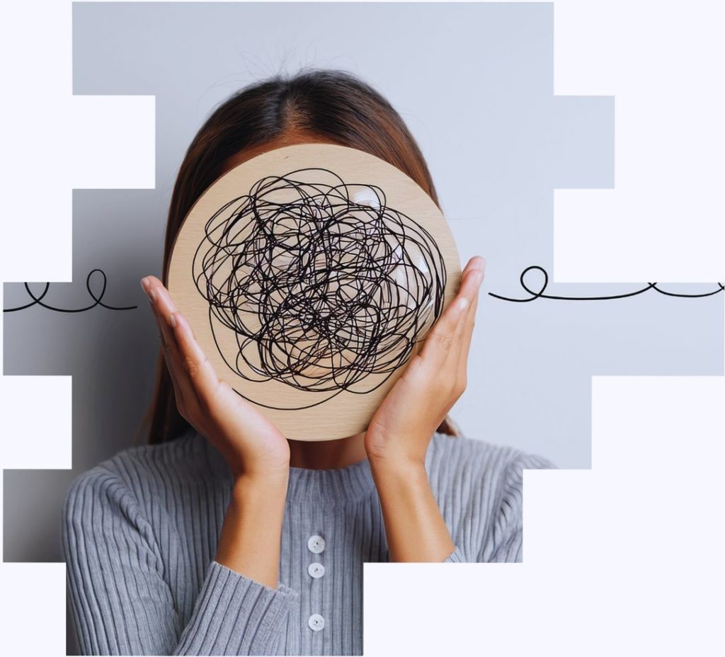 An image of a woman holding a block of wood with squiggly lines on it to represent the mental health effects of night shift work