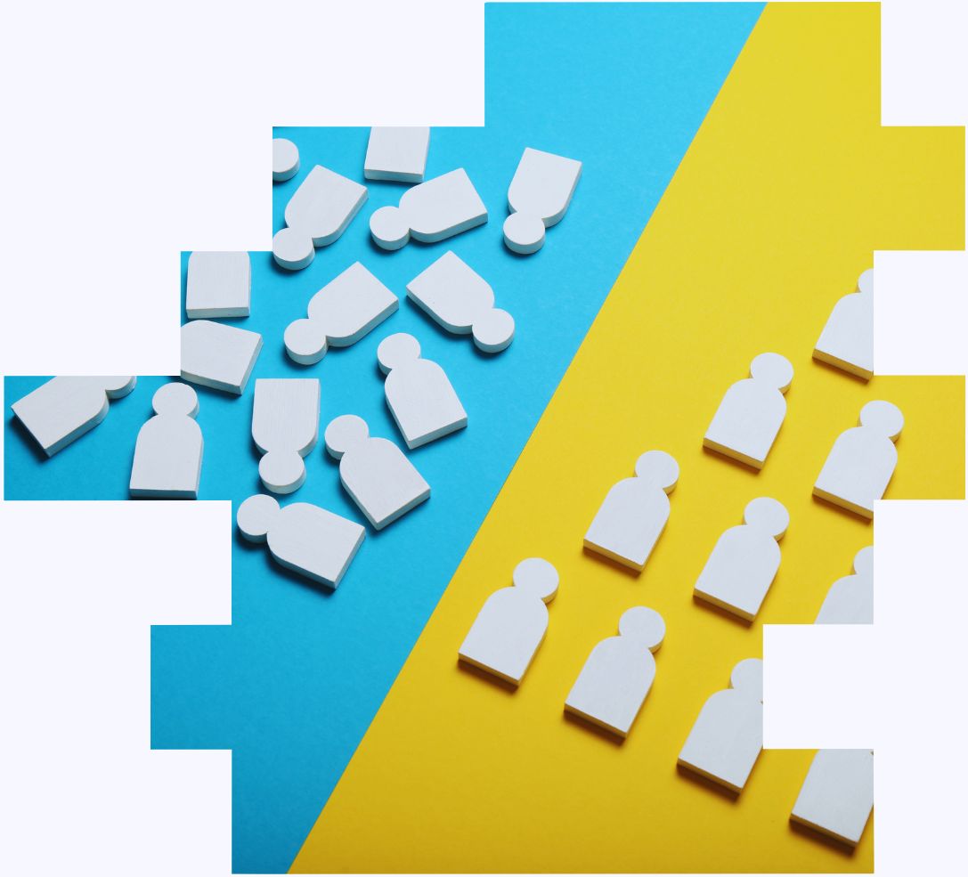 An image of a set of wooden cut outs of people being organised into straight lines to illustrate how a shift work risk assessment looks at demand and capacity and shift patterns