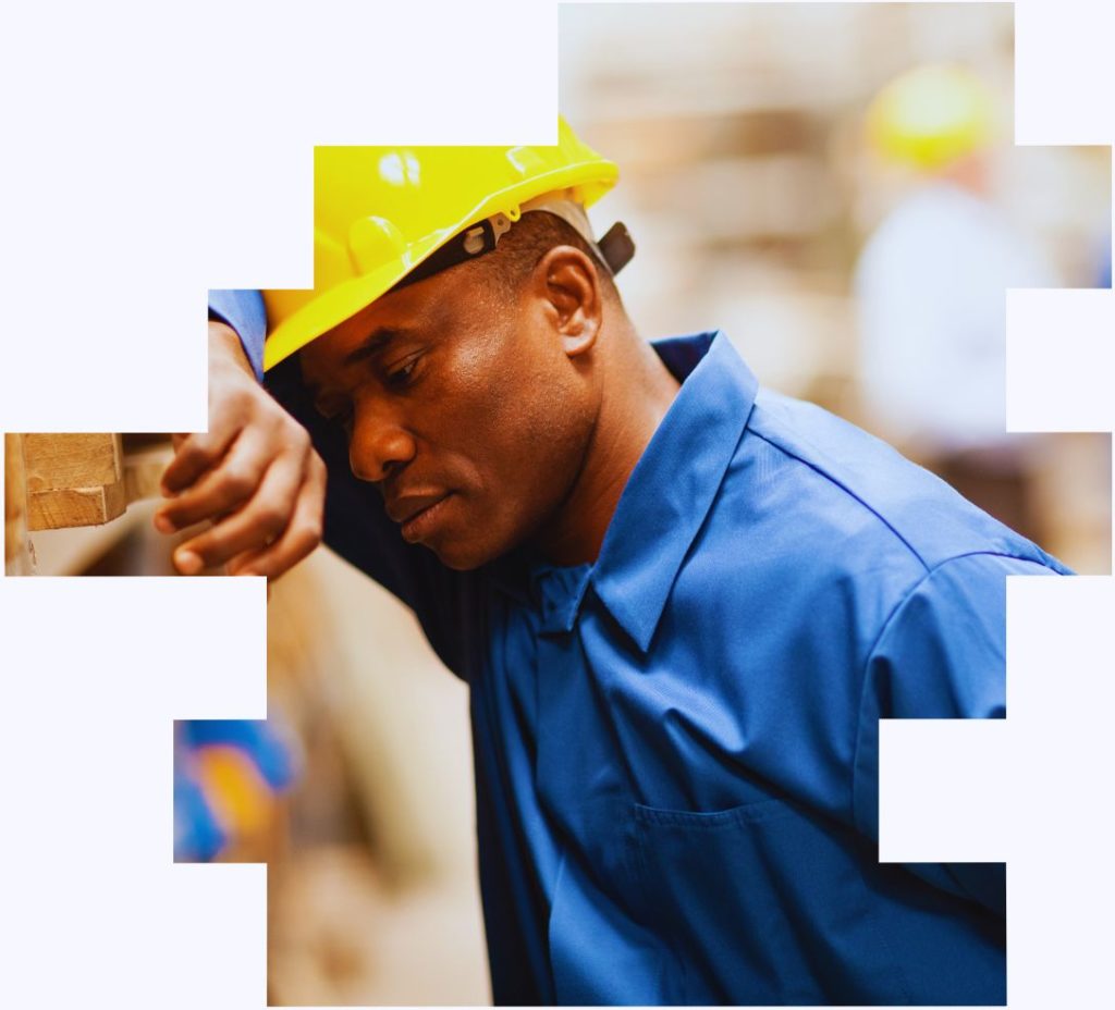 A worker in a hard hat looking tired to illustrate how a shift work risk assessment covers shift worker health and wellbeing support and comms and engagement