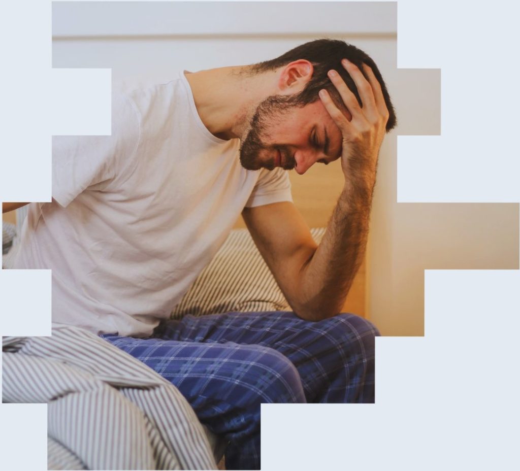 An image of a man on his bed suffering from fatigue to illustrate how shift work fatigue management is crucial to employee health and wellbeing support
